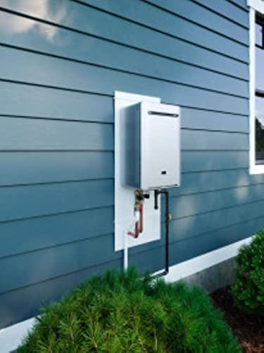 White rectangular tankless water heater mounted on blue horizontal siding with gas and water connection lines visible below.