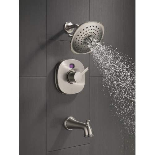 Chrome tub and shower system with round showerhead, lever handle, and pull-up diverter spout mounted on gray tile wall.