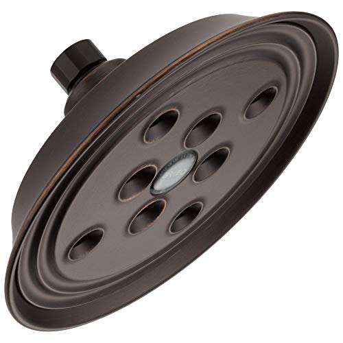 Round dark bronze shower head with multiple spray holes and wall mount connection.