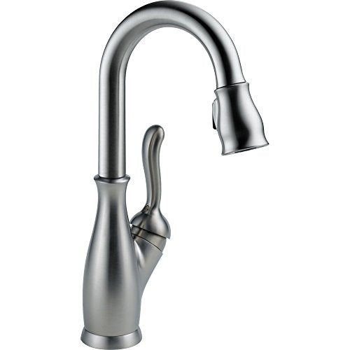 Chrome single-handle faucet with curved spout and pull-down spray head.