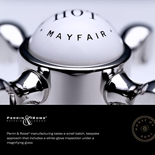 Polished chrome two-handle kitchen faucet with curved spout and side spray attachment.