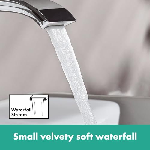 Chrome single-hole faucet with flat rectangular spout dispensing water in a waterfall stream pattern.