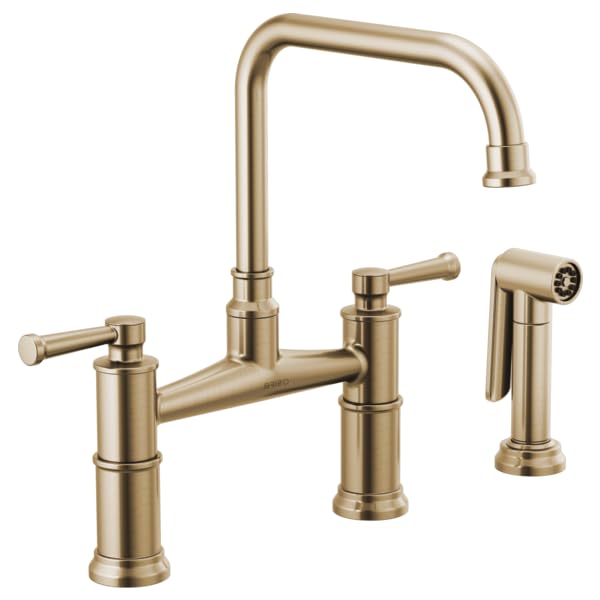 Champagne bronze bridge faucet with tall arched spout, dual lever handles, and detachable side sprayer.