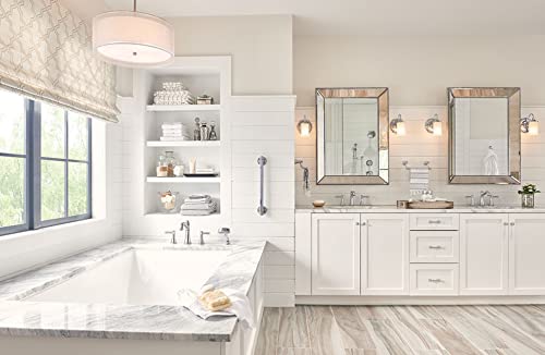Polished nickel Roman tub faucet trim with curved spout and handheld shower wand mounted on bathroom wall.