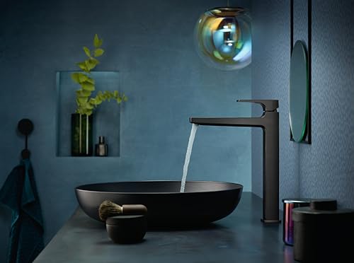 Brushed black chrome single-hole faucet with tall lever handle mounted above black vessel sink with water running.