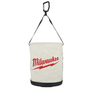 Cream canvas utility bucket with black carabiner handle, black straps, black base trim, and red Milwaukee logo on front.