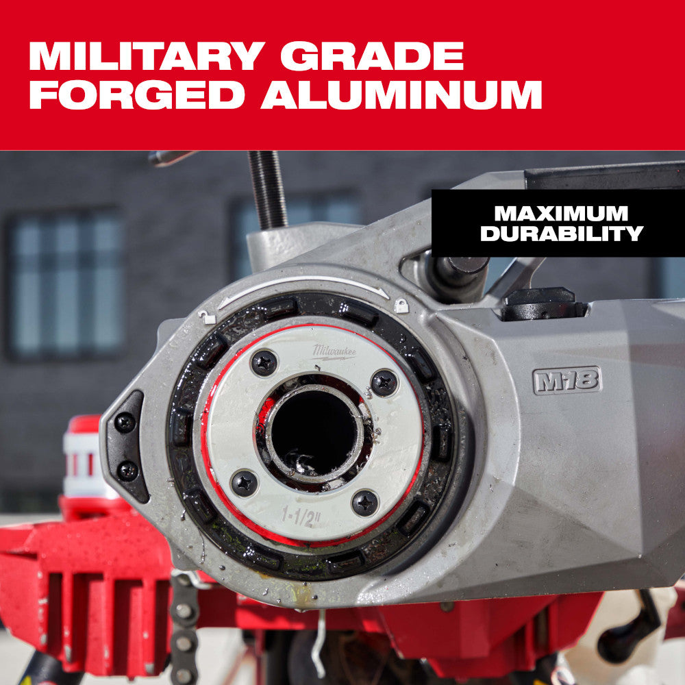 Milwaukee 1-1/4" forged aluminum die head with threaded center opening and mounting bolts on red machine base.