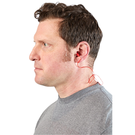 Man wearing corded ear plugs with red cable connecting both earpieces behind his neck.