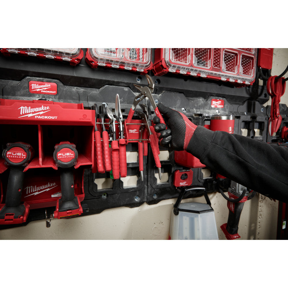 Red and black Milwaukee PACKOUT tool rack mounted on wall with various hand tools and storage organizers attached.