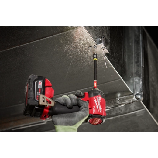 Steel hawg cutter with quick change tang drive held in gloved hand next to red power drill.