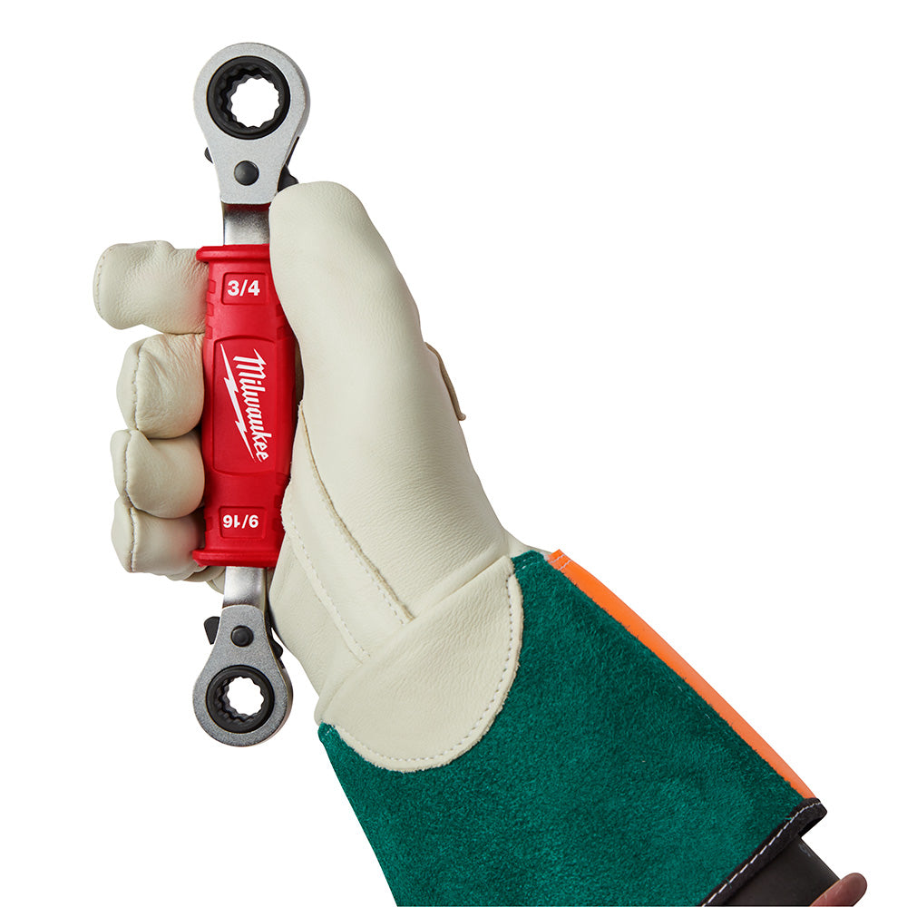 Milwaukee ratcheting box wrench with insulated red handle held in gloved hand, showing 3/4 and 9/16 socket sizes.