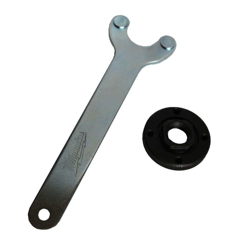 Metal spanner wrench with two studs and black rubber flange nut with center hole.