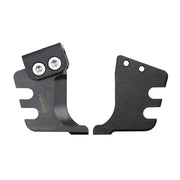 Two black metal replacement blades with notched edges and mounting holes, one featuring two circular screw connections.