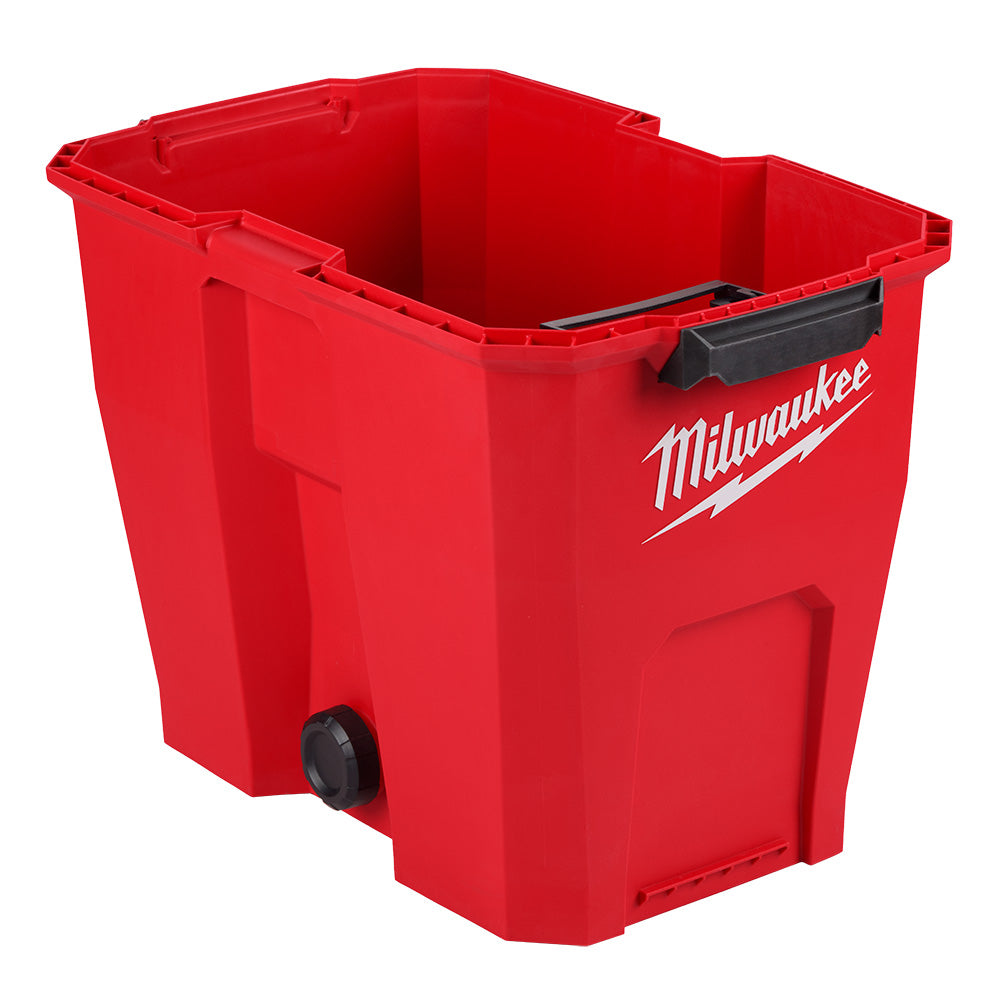 Red plastic vacuum tank with Milwaukee branding, black handle, and drain plug on lower side.