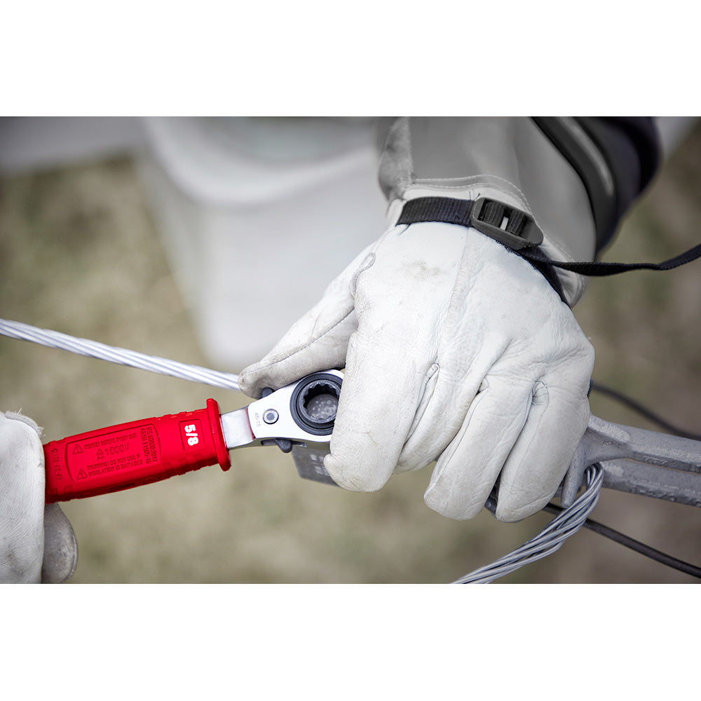Worker in white gloves holding ratcheting box wrench with red insulated handle and metal head.
