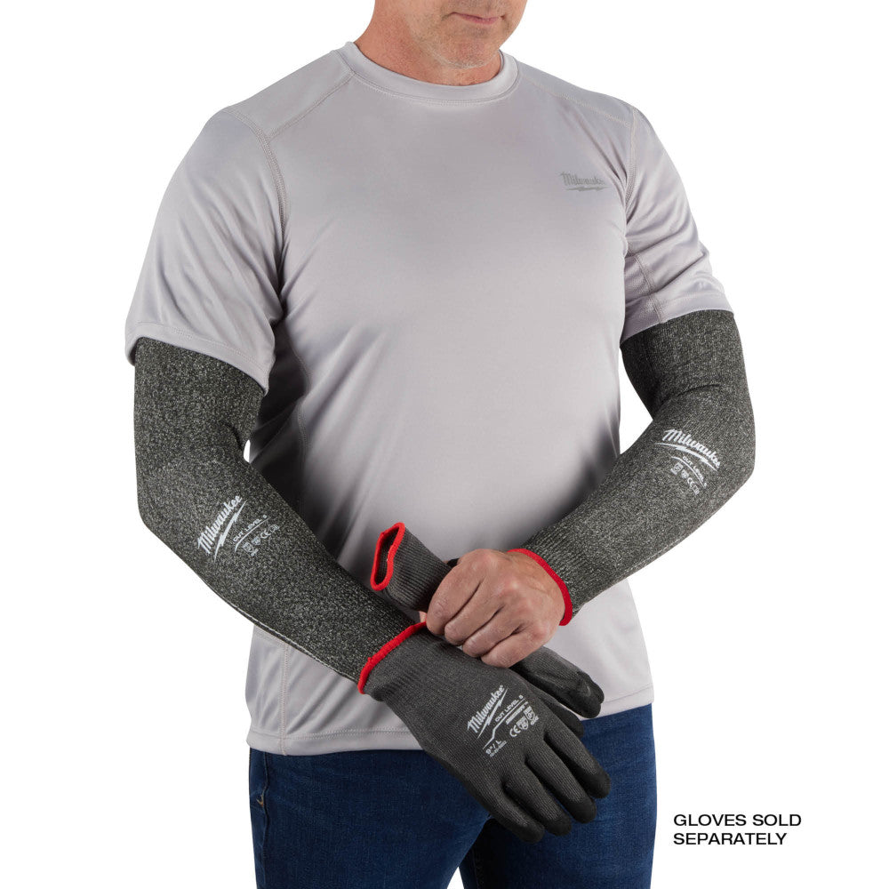 Gray cut-resistant sleeves with red cuff trim worn on forearms over gray shirt.