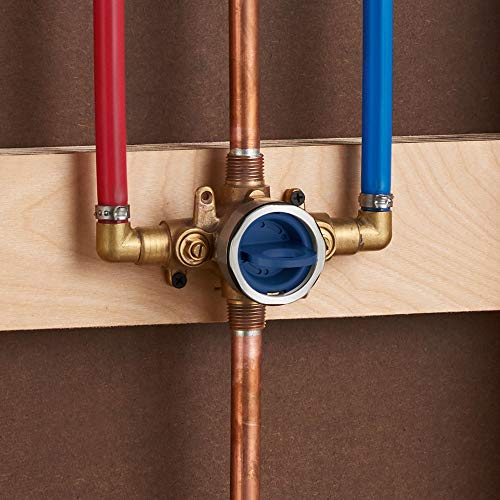 Brass pressure balance valve with red, copper, and blue inlet pipes mounted in wood framing.