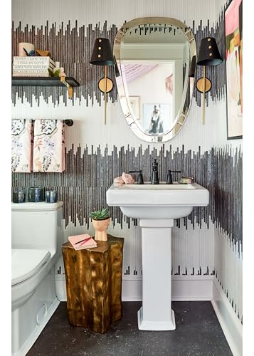 White pedestal sink with matte black widespread faucet and pop-up drain in bathroom with patterned wall tiles.