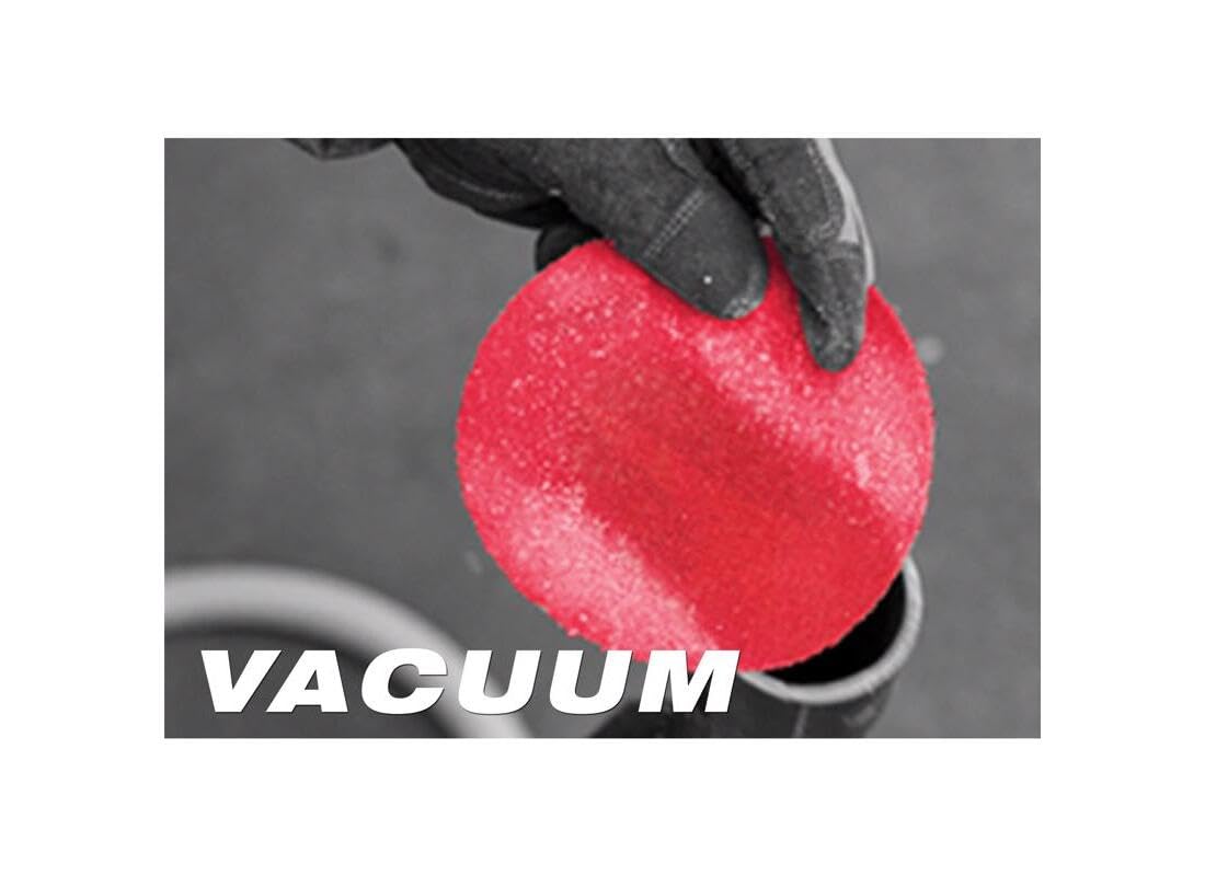 Red sanding sheet with perforated vacuum holes held in a gloved hand.