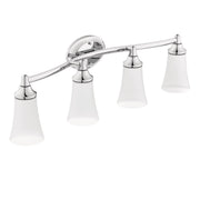 Four-light chrome vanity fixture with frosted white glass shades and curved arm, mounted to circular backplate.