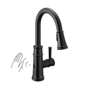 Matte black pulldown kitchen faucet with curved spout, single handle, and motion sensor activation shown with hand gesture.