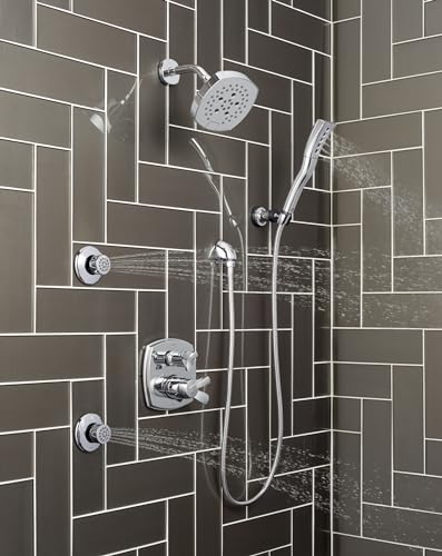 Delta Stryke champagne bronze shower system with integrated diverter, overhead rainfall head, handheld wand, and multiple bod