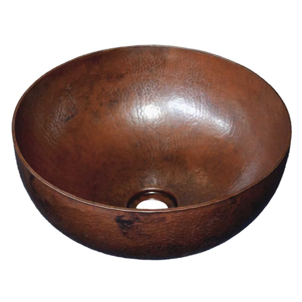 Antique copper bowl sink with hammered surface and single drain hole.