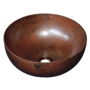 Antique copper bowl sink with hammered surface and single drain hole.