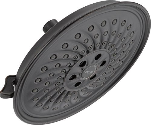 Matte gray round shower head with multiple spray holes and adjustment dial, mounted on articulated arm.