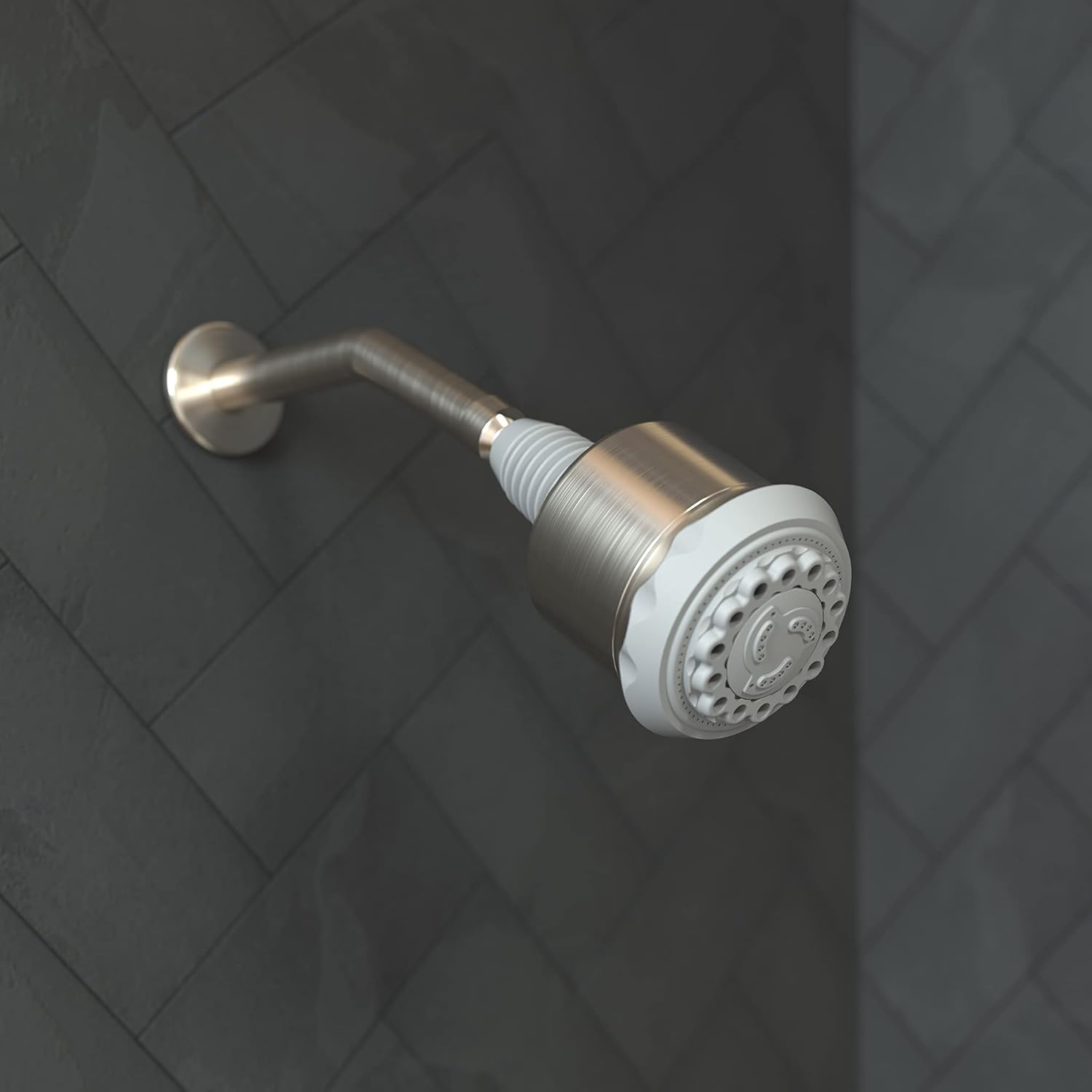 Brushed nickel shower head with white accent ring and curved metal arm mounted on dark tiled wall.