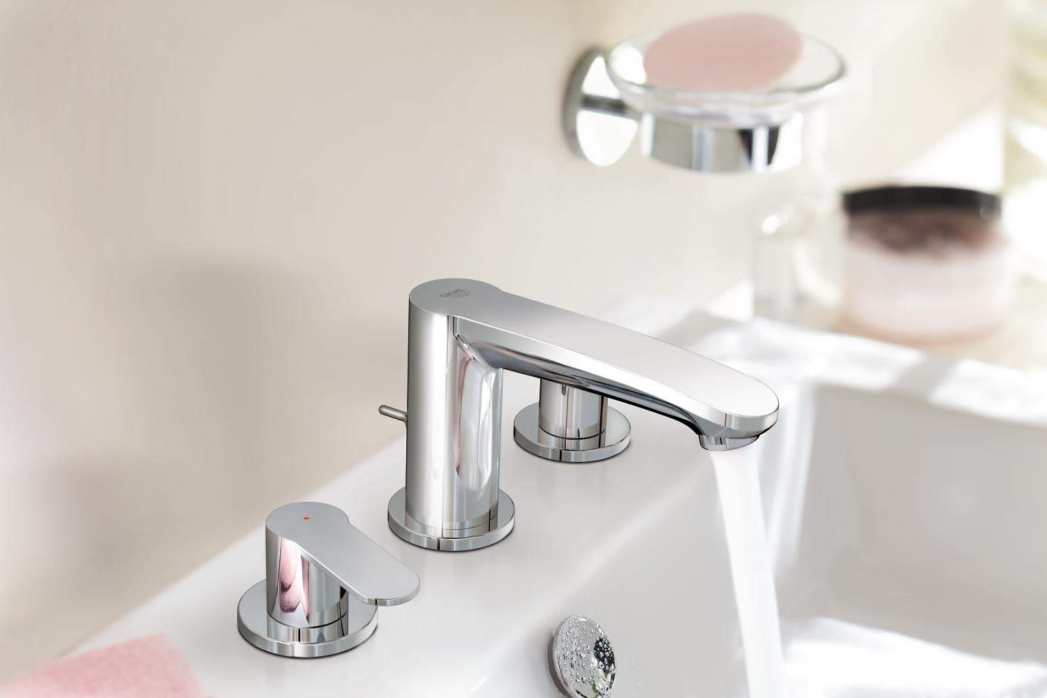 Chrome widespread bathroom faucet with two handles and curved spout mounted on white sink deck.