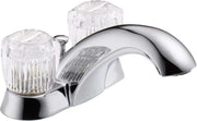 Chrome bathroom faucet with two clear knob handles and curved spout with pop-up drain assembly.