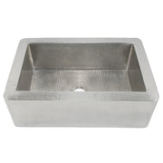 Brushed nickel single-basin farmhouse sink with hammered interior and exterior surfaces, front apron style.