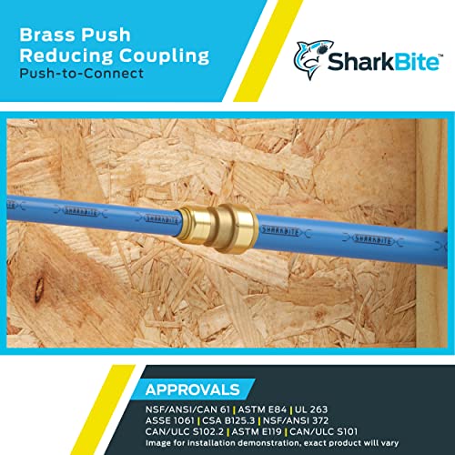Brass reducing coupling fitting with push-to-connect ends connecting two different diameter blue pipes.