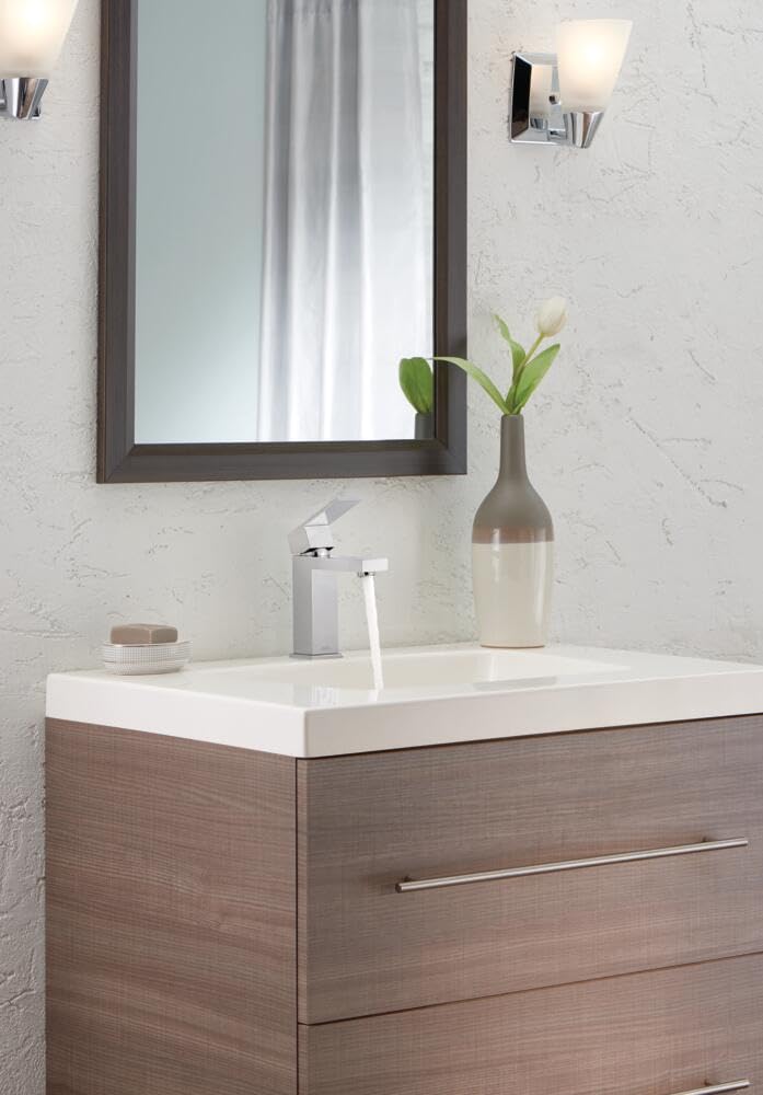 Chrome single-handle bathroom faucet with curved spout mounted on white sink counter.