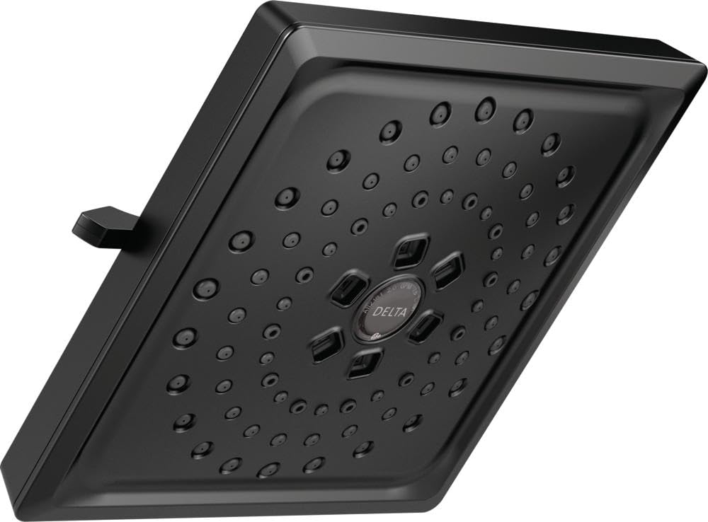 Matte black square shower head with multiple spray holes and central control dial, mounted at an angle.