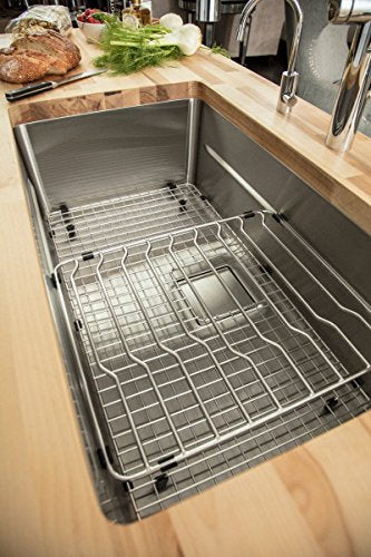 Stainless steel grid insert for bar sink with cross-wire design and mounting brackets.