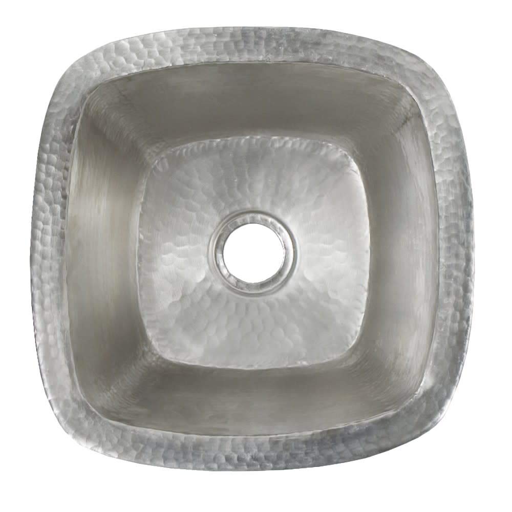 Small square hammered copper bar sink with rounded corners and center drain opening, viewed from above.