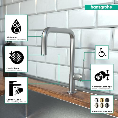 Steel Optic U-shaped kitchen faucet with single spray head mounted on countertop with subway tile backsplash.