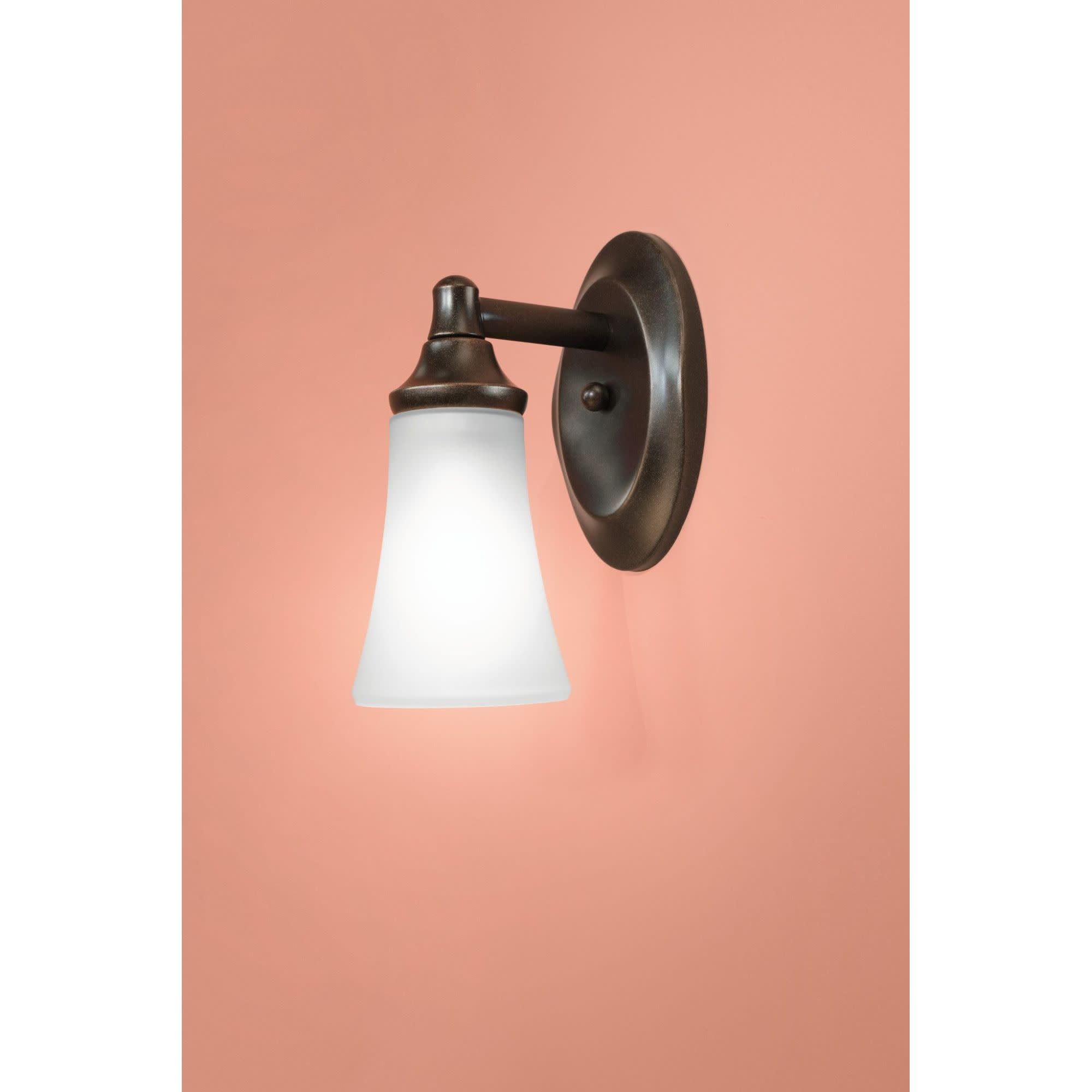 Oil-rubbed bronze wall-mounted vanity light with conical frosted glass shade and adjustable arm.