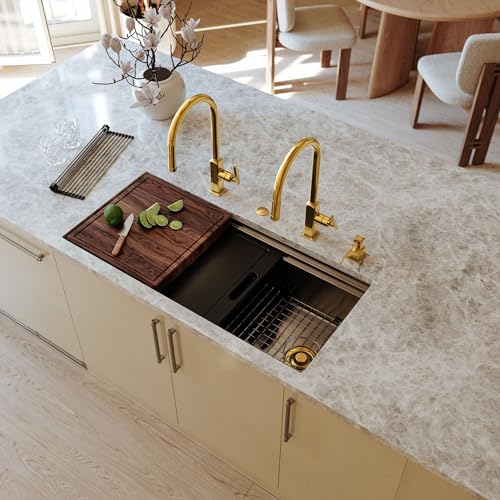 Antique gold disposal flange ring for kitchen sink drain opening, shown installed on undermount sink.