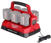Red and black Milwaukee rapid charger with six battery slots, carrying handle, and attached power cord.