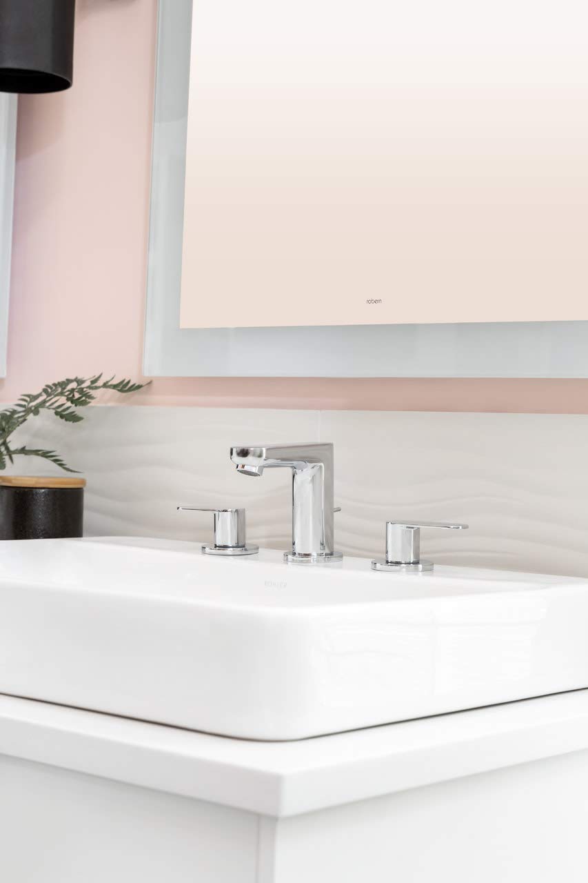Chrome widespread bathroom faucet with two handles and tall center spout mounted on white sink.