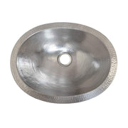 Oval hammered copper bathroom sink with single drain hole and textured rim, shown from above.
