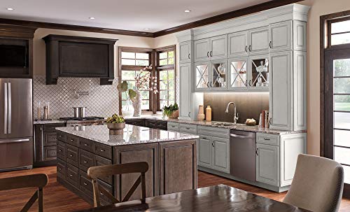 Chrome wall-mounted pot filler faucet installed above kitchen island sink in traditional style kitchen.