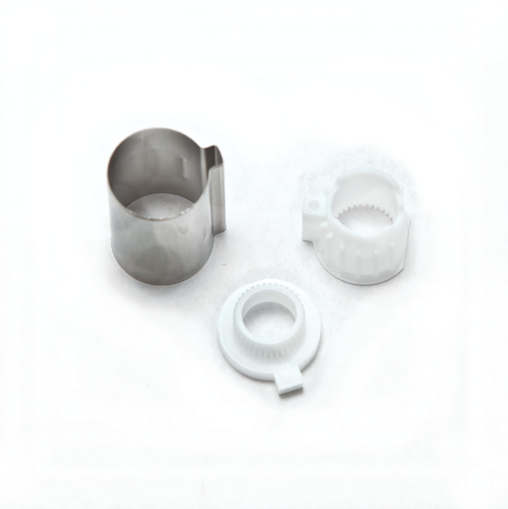 Wrought iron stop tube component with two white plastic adapter rings for Moen Posi-Temp faucet systems.