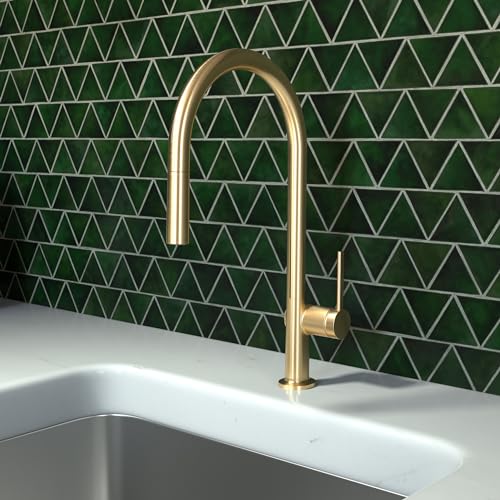 Brushed gold high-arc kitchen faucet with pull-down spray mounted above stainless steel sink.