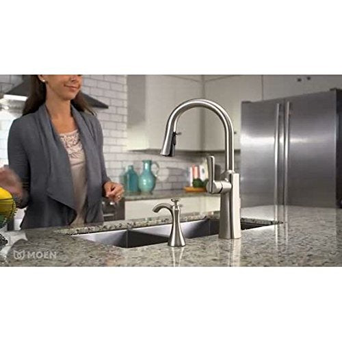 Oil-rubbed bronze deck-mounted kitchen soap dispenser with refillable bottle displayed on sink countertop.