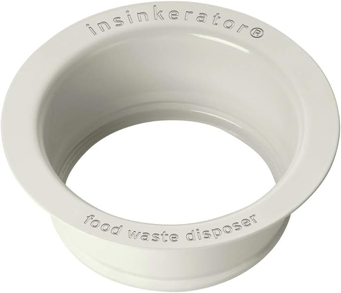 Biscuit-colored plastic sink flange with InSinkErator branding and food waste disposer text molded into surface.