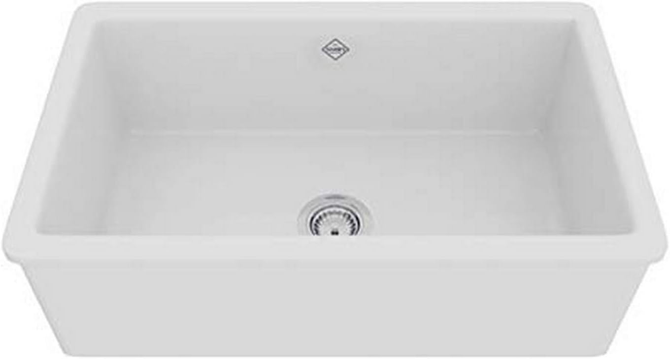 White fireclay kitchen sink with single rectangular basin and drain, viewed from above at an angle.